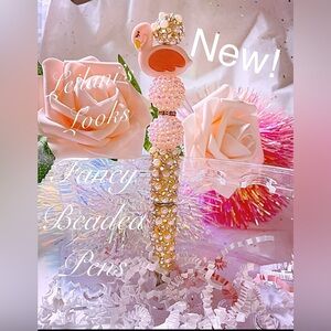 Elegant pen with pink and gold beads. Features a cute swan design